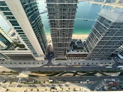 an aerial view of a city with tall buildings at Manzil - 1BR Apartment in Emaar Beachfront with Private Beach & Marina Access in Dubai