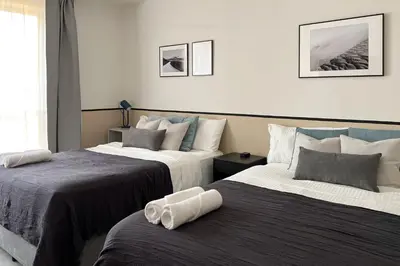 two beds in a hotel room with two beds at FavDubai presents 2BR apartment in The Heart of JBR and Dubai Marina 150 m to JBR Beach with famous Ain Dubai view the biggest ferris wheel in the world Swimming pool access, air-conditioned gym, free parking & Housekeeping in Dubai