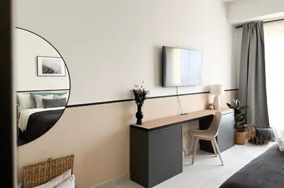a bedroom with a desk and a bed with a mirror at FavDubai presents 2BR apartment in The Heart of JBR and Dubai Marina 150 m to JBR Beach with famous Ain Dubai view the biggest ferris wheel in the world Swimming pool access, air-conditioned gym, free parking & Housekeeping in Dubai