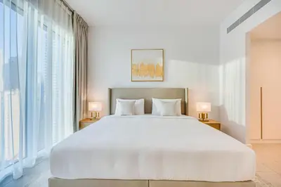 a bedroom with a large white bed and large windows at Panoramic sea view from new 2BD in La Vie JBR in Dubai