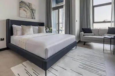 a bedroom with a large bed and a couch at Frank Porter - 15 Northside in Dubai