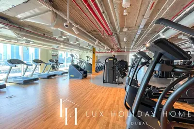 a gym with treadmills and cardio equipment in a building at LUX The Downtown Zabeel View Suite 2 in Dubai