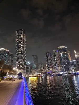a city skyline at night with a river and buildings at Stella Maris High Floor,Stunning Skyline Views in Dubai