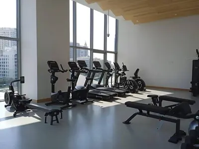 a gym with a row of tread machines in a room at Stella Maris High Floor,Stunning Skyline Views in Dubai