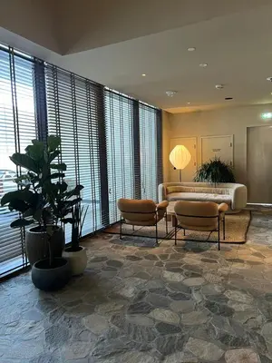 a living room with a couch and chairs and windows at UPSIDE LIVING Downtown Business & Leisure in Dubai