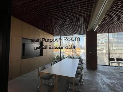 a conference room with a white table and chairs at UPSIDE LIVING Downtown Business & Leisure in Dubai