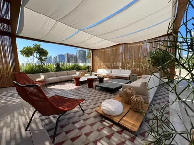 a living room with a couch and a chair at UPSIDE LIVING Downtown Business & Leisure in Dubai