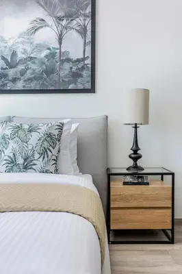 a bedroom with a bed and a table with a lamp at Frank Porter - Ahad Residences in Dubai