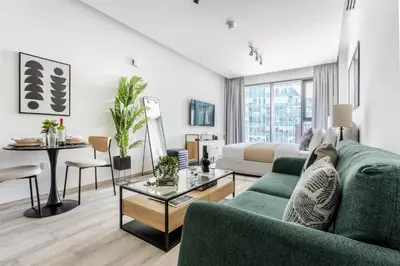a living room with a couch and a table at Frank Porter - Ahad Residences in Dubai