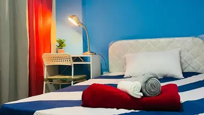 a bedroom with a bed with towels on it at Nicest Partition Room in Barsha Heights Near Internet City Metro in Dubai