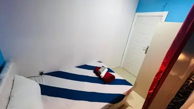 a small room with a bed with a red bag on it at Nicest Partition Room in Barsha Heights Near Internet City Metro in Dubai