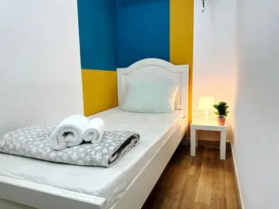 a bedroom with a bed with towels on it at Decent Partition Room in Barsha Heights Near Metro in Dubai