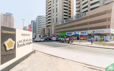 a street in a city with a sign and buildings at Decent Partition Room in Barsha Heights Near Metro in Dubai