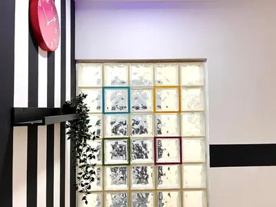 a glass block window with a clock on a wall at Seperate Partition Room in Tecom / Barsha Heights in Dubai