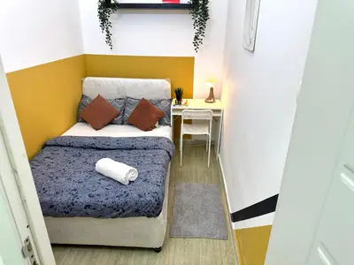 a small bedroom with a bed and a desk at lavish Partition Room in Barsha Heights Near Internet City Metro in Dubai