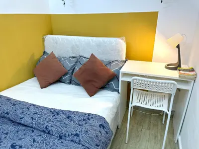a small bedroom with a bed and a desk at lavish Partition Room in Barsha Heights Near Internet City Metro in Dubai