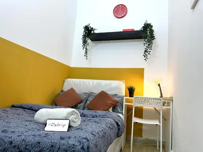 a bedroom with a bed with a blue comforter at lavish Partition Room in Barsha Heights Near Internet City Metro in Dubai