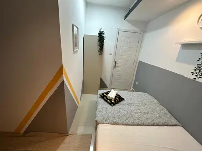 a small room with a bed and a white door at Double Partition Room in Al Barsha 1 Nearest to Metro in Dubai