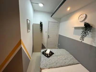 a small room with a bed and a white door at Double Partition Room in Al Barsha 1 Nearest to Metro in Dubai