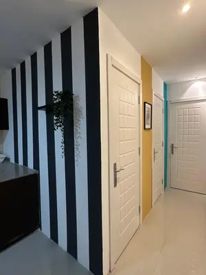a hallway with black and white stripes on the wall at Double Partition Room in Al Barsha 1 Nearest to Metro in Dubai