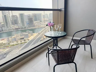 a table and two chairs in a room with a window at Modern Studio, Canal View, Elite Downtown, Dubai - 13AB06 in Dubai