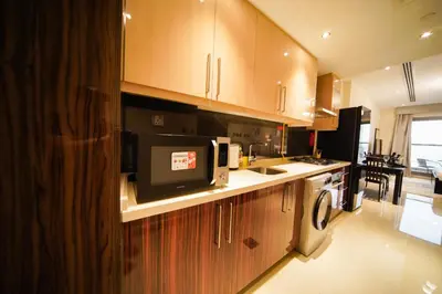 a kitchen with a microwave and a dishwasher at Modern Studio, Canal View, Elite Downtown, Dubai - 13AB06 in Dubai