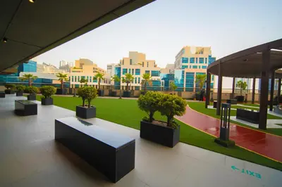 a group of potted trees in a building at Modern Studio, Canal View, Elite Downtown, Dubai - 13AB06 in Dubai