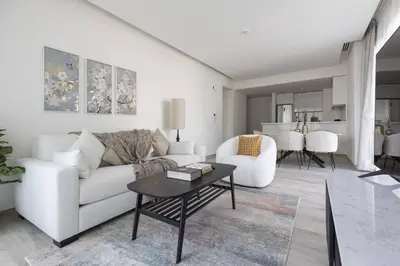 a living room with a white couch and a table at Ahad Residence Walking Distance to Dubai Mall in Dubai