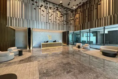 a lobby with chairs and a reception desk in a building at Ahad Residence Walking Distance to Dubai Mall in Dubai