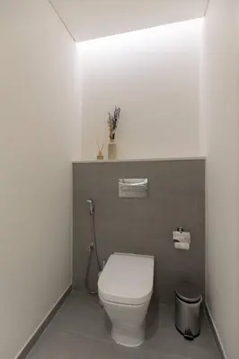 a bathroom with a white toilet and a sink at Ahad Residence Walking Distance to Dubai Mall in Dubai