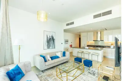 a living room with a couch and a table at HomesGetaway- 2BRLuxury Apartment at Marina Gate 2 in Dubai
