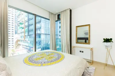 a bedroom with a bed and a large window at HomesGetaway- 2BRLuxury Apartment at Marina Gate 2 in Dubai