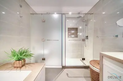 a shower with a glass door in a bathroom at Plush 2BR at Grand Opera Downtown Dubai by Deluxe Holiday Homes in Dubai