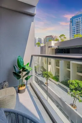 an apartment balcony with a view of a city at Luxurious Flat 3 Min to Burj Khalifa Sleeps 3 in Dubai