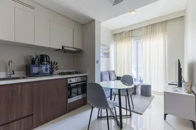 a kitchen and dining room with a table and chairs at Business Bay Gem1 bd apt with Scenic Canal Views in Dubai