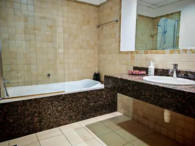 a bathroom with a tub and a sink at Spacious 2BR Apt on JBR Beach near Mall & Metro By La Buena Vida Holiday Homes in Dubai