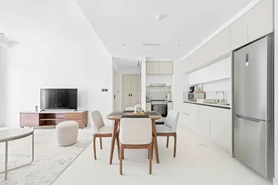 a kitchen and dining room with a table and chairs at Silkhaus Sea View 1BDR in Marina Vista, near Marina in Dubai