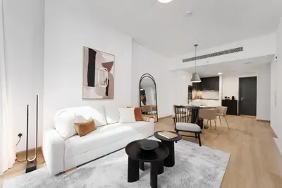 a living room with a white couch and a table at Luxe Living in our Exquisite 1 Bedroom Apartment in Dubai
