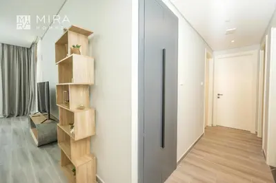 a hallway of a house with a book shelf at Mira Holiday Homes - Spacious 2 bedroom in Midtown in Dubai