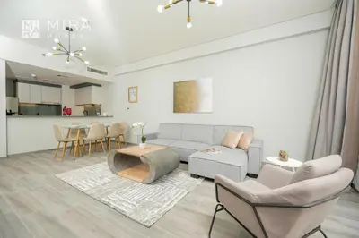 a living room with a couch and chairs and a table at Mira Holiday Homes - Spacious 2 bedroom in Midtown in Dubai