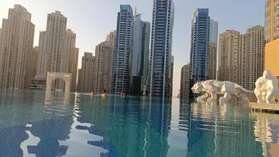 a swimming pool in a city with tall buildings at Seaview & Marina View Studio in Dubai