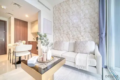 a living room with a white couch and a table at Special Deal Contemporary 1BR with Canal Views by Deluxe Holiday Homes in Dubai
