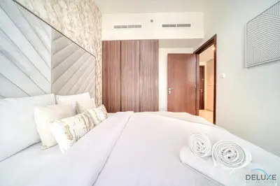 a bedroom with a large white bed with two pillows at Special Deal Contemporary 1BR with Canal Views by Deluxe Holiday Homes in Dubai
