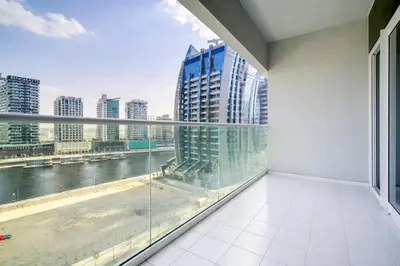 a balcony with a view of a river and buildings at Special Deal Contemporary 1BR with Canal Views by Deluxe Holiday Homes in Dubai