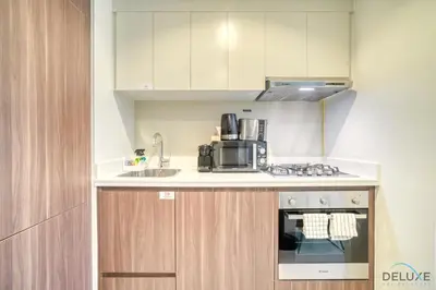 a kitchen with a sink and a stove top oven at Special Deal Contemporary 1BR with Canal Views by Deluxe Holiday Homes in Dubai