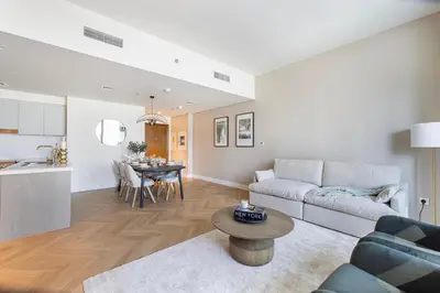 a living room and kitchen with a couch and a table at Daniels Luxury 3BR with Dubai Opera Views in Dubai