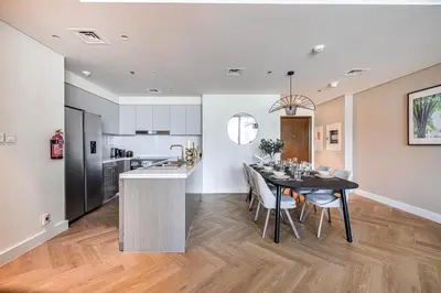a kitchen and dining room with a table and chairs at Daniels Luxury 3BR with Dubai Opera Views in Dubai