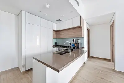 a kitchen with white cabinets and a counter top at StoneTree - Elegant 1BR with Stunning View of Marina in Dubai