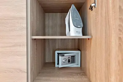 a small cabinet with a microwave and a phone at StoneTree - Elegant 1BR with Stunning View of Marina in Dubai