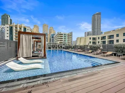 a large swimming pool on top of a building at StoneTree - Elegant 1BR with Stunning View of Marina in Dubai